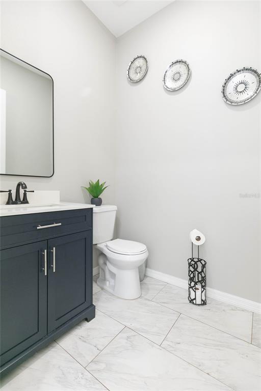 35369 Ruffing Road Dade City, FL 33523 - Photo 9 of 63 a bathroom with a toilet a sink and mirror