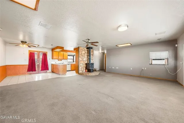 a utility room with stainless steel appliances granite countertop a sink and a cabinets