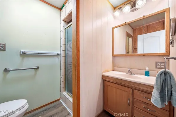 a large kitchen with stainless steel appliances granite countertop a stove a sink and a microwave