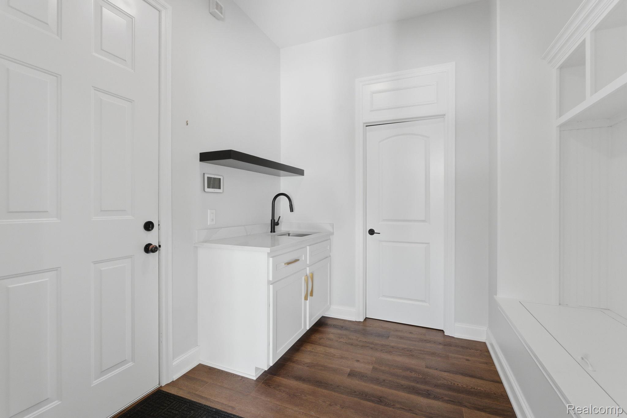 8844 Ridge Drive Washington, MI 48095 - Photo 14 of 51 Laundry area with dark wood-style floors and a sink