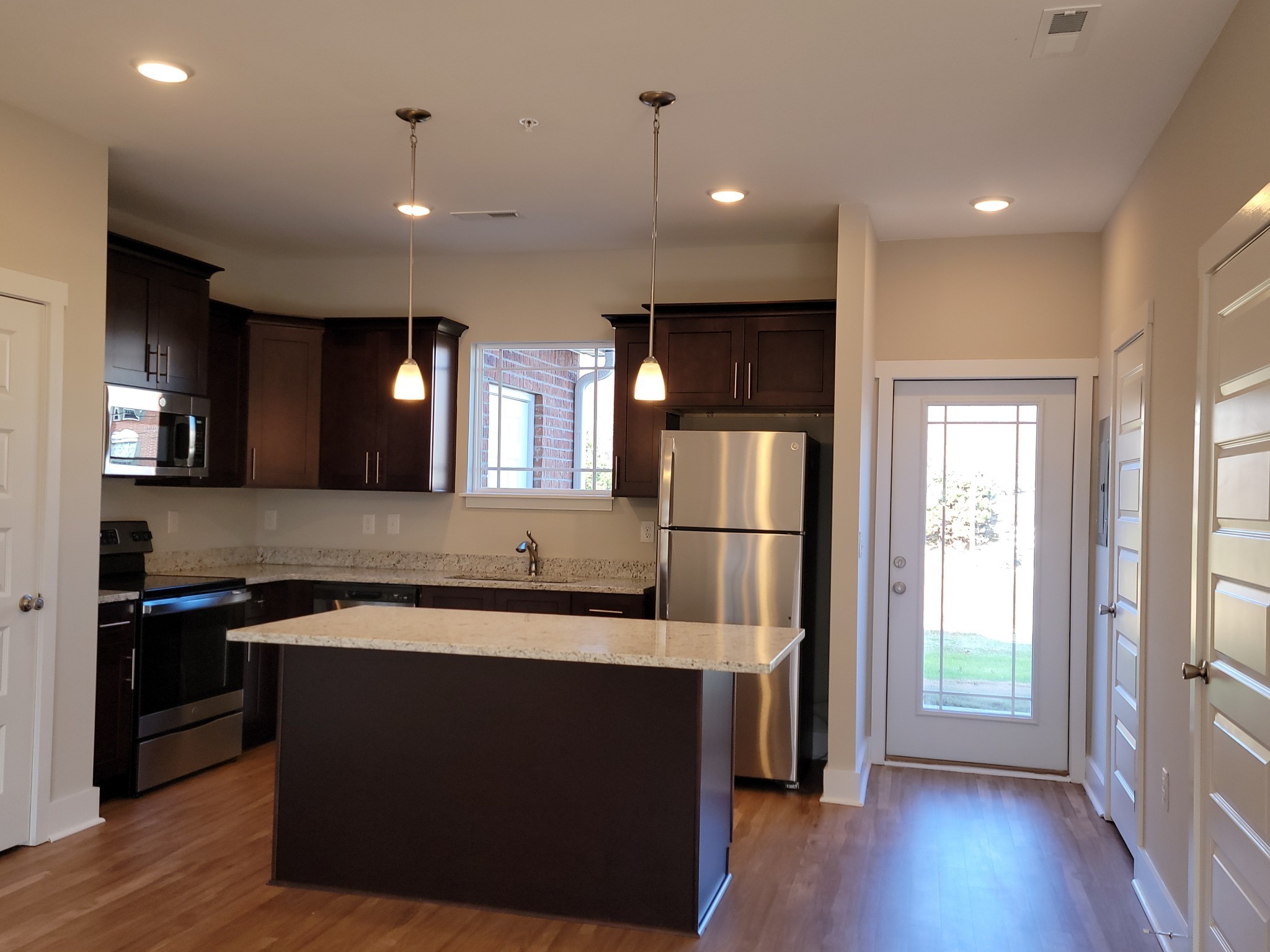 4011 Angelica Ct Spring Hill Spring Hill, TN 37174 - Photo 3 of 15 a kitchen with stainless steel appliances granite countertop a refrigerator a sink a stove and a wooden floors