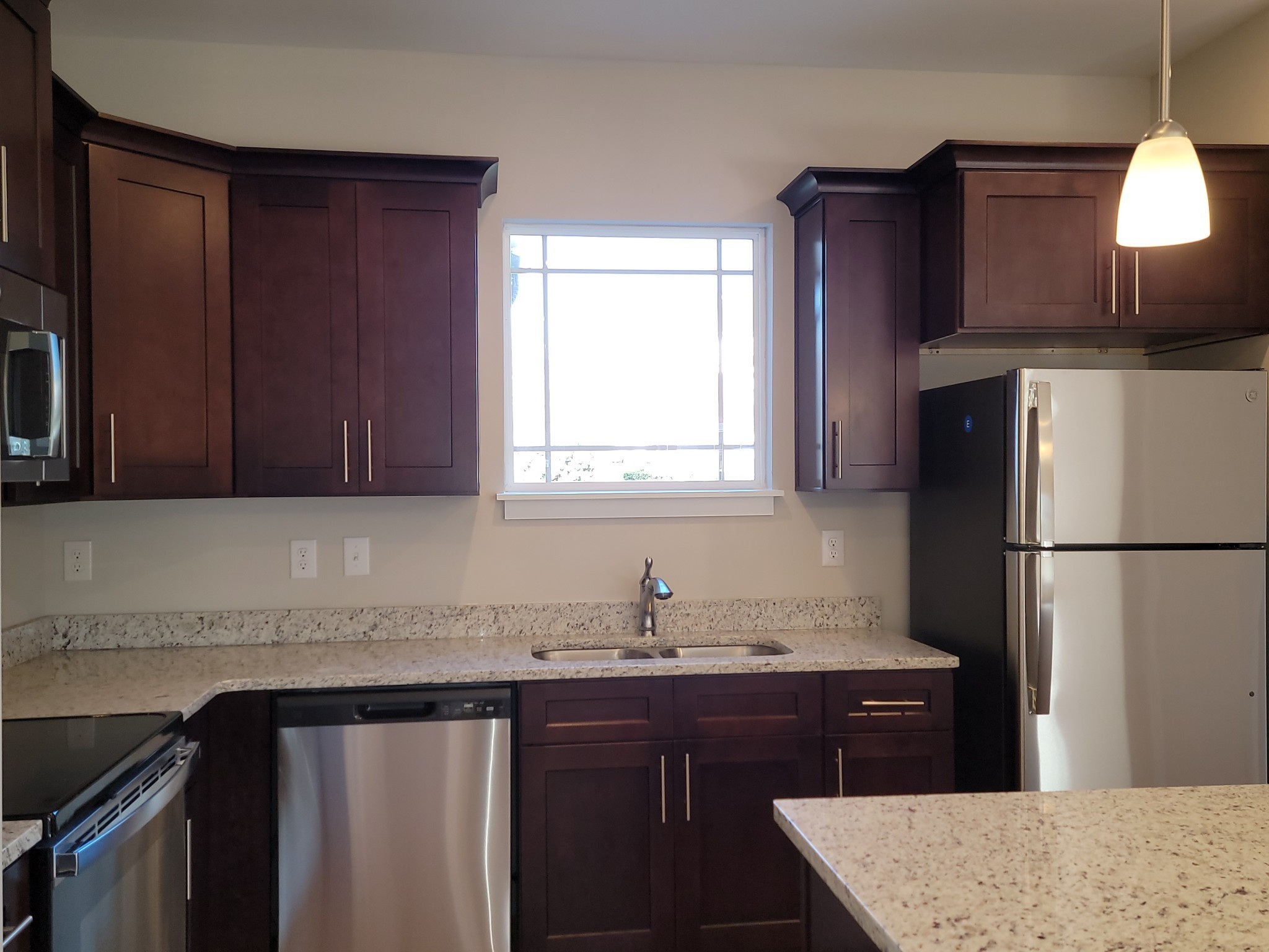 4011 Angelica Ct Spring Hill Spring Hill, TN 37174 - Photo 4 of 15 a kitchen with granite countertop a refrigerator a sink and wooden cabinets