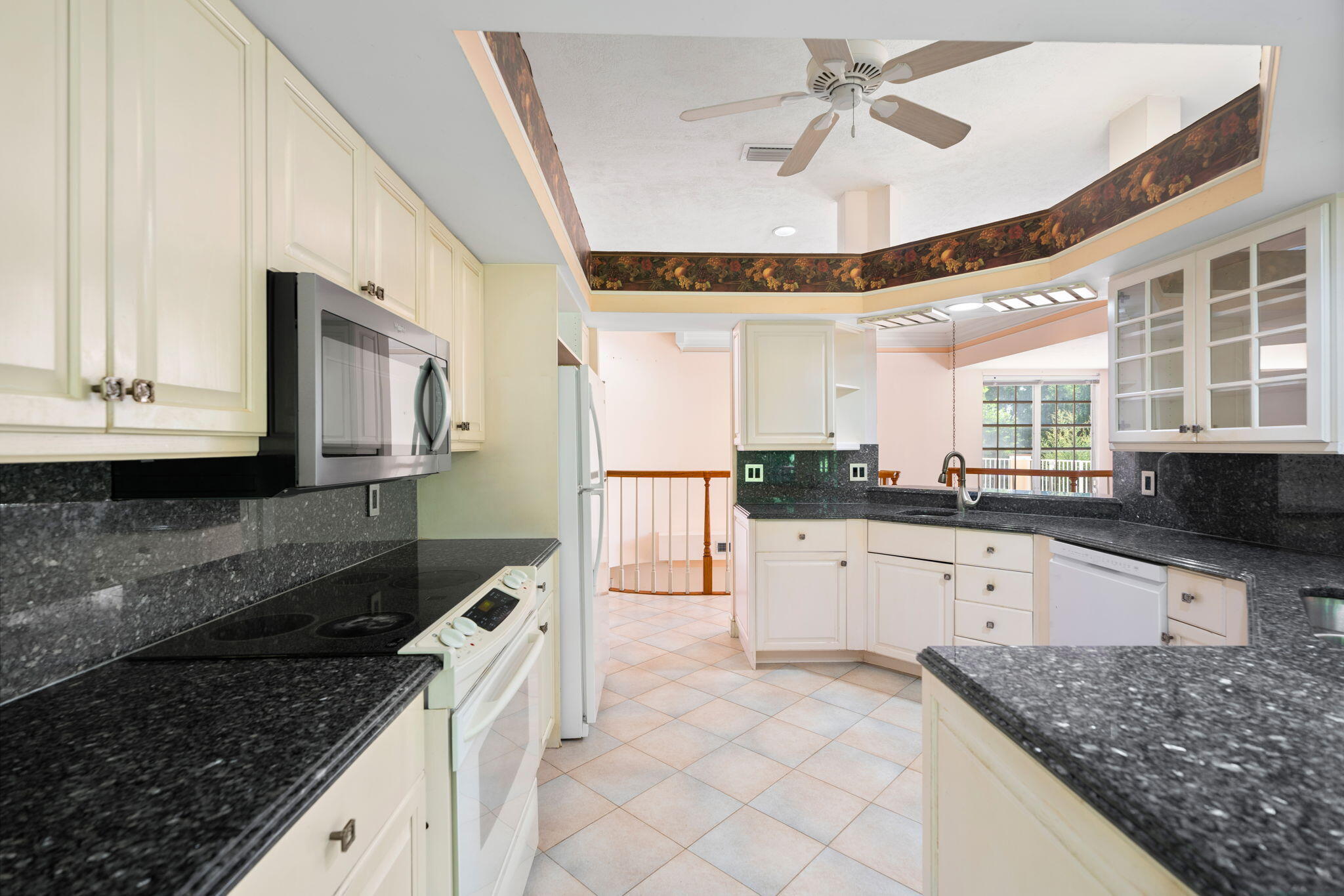 6 Castle Hill Way Sewall's Point, FL 34996 - Photo 21 of 31 a kitchen with granite countertop a sink a counter top space appliances and cabinets