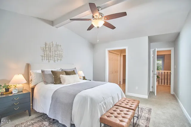 a bedroom with a bed and a lamp with a chandelier