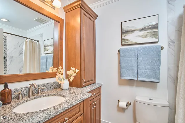 a bathroom with a granite countertop sink a mirror and a shower