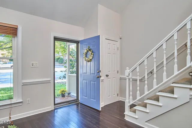 a view of entryway with wooden floor and front door