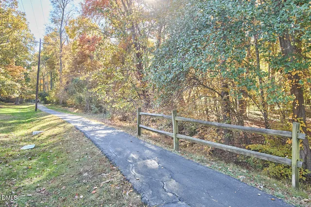 a view of backyard with wooden fence
