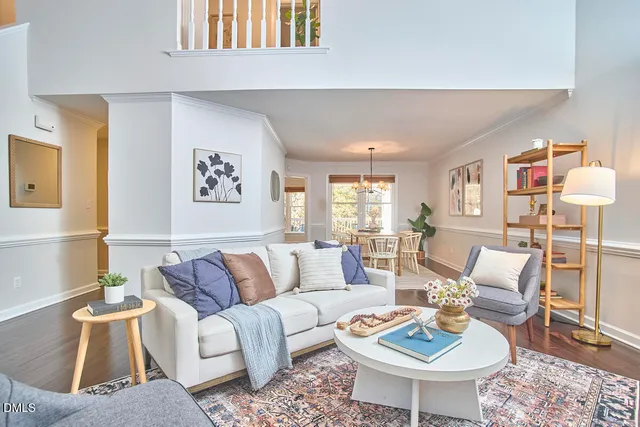 a living room with furniture a rug and a window