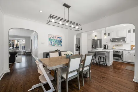 a view of a dining room with furniture wooden floor and chandelier