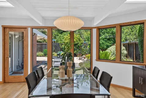 a view of a dining room with furniture window and wooden floor