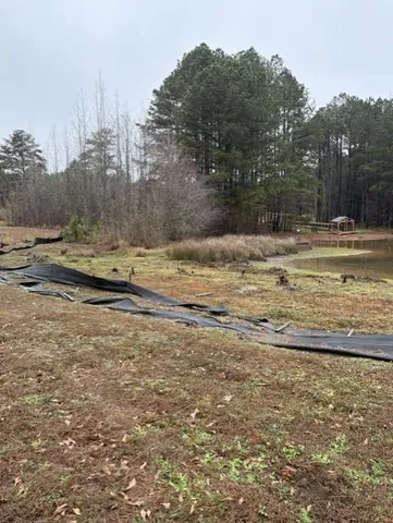 a view of a yard with wooden fence