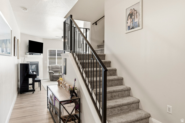 668 East Fiddlers Canyon Road, Unit 6 Cedar City, UT 84721 - Photo 14 of 36 Carpeted staircase with black metal balusters and handrail