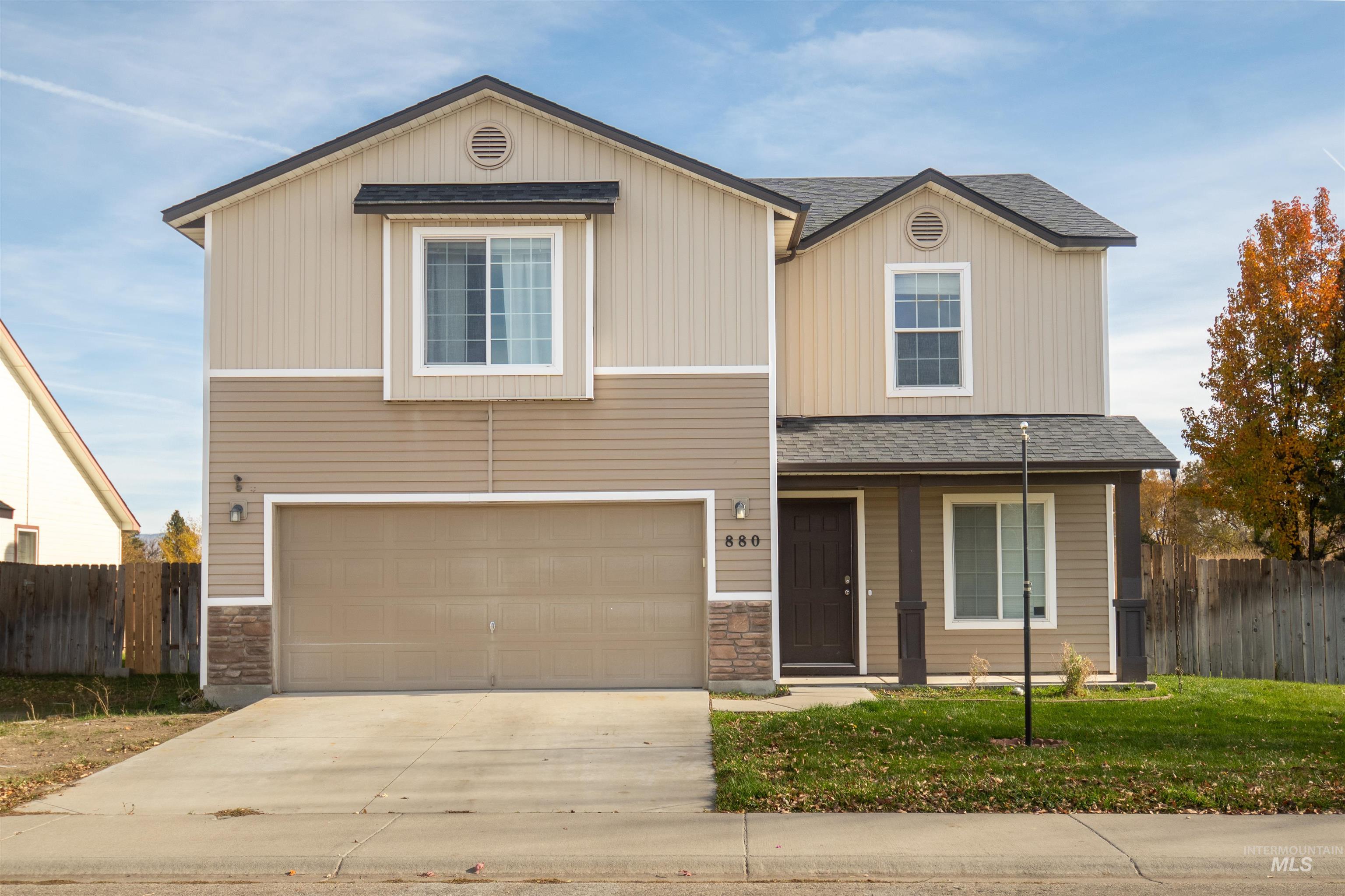 880 Southwest Independence Mountain Home, ID 83647 - Photo 1 of 50 View of front facade featuring a shingled roof, stone siding, a garage, and driveway