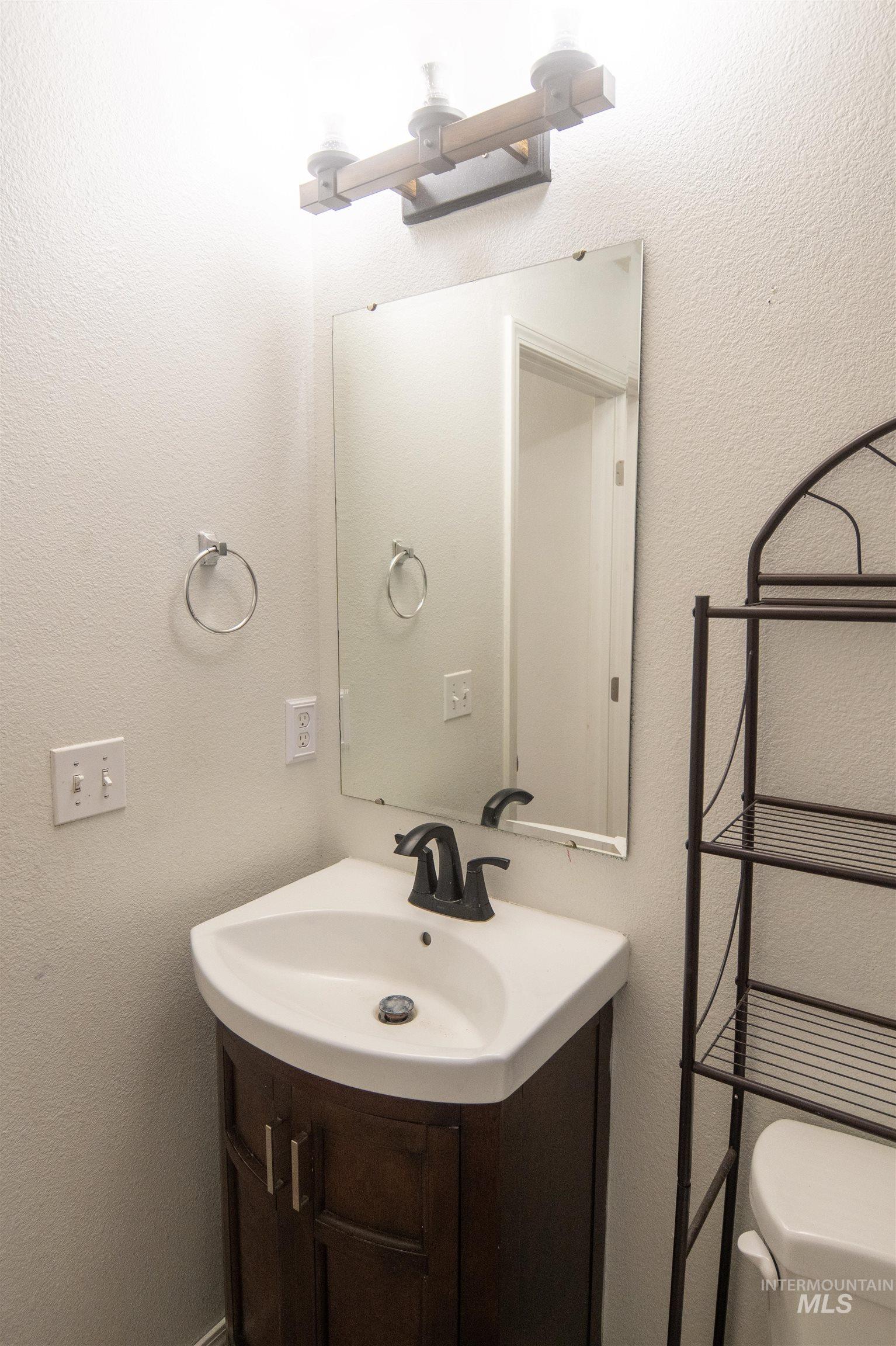 880 Southwest Independence Mountain Home, ID 83647 - Photo 11 of 50 Bathroom with a textured wall and vanity