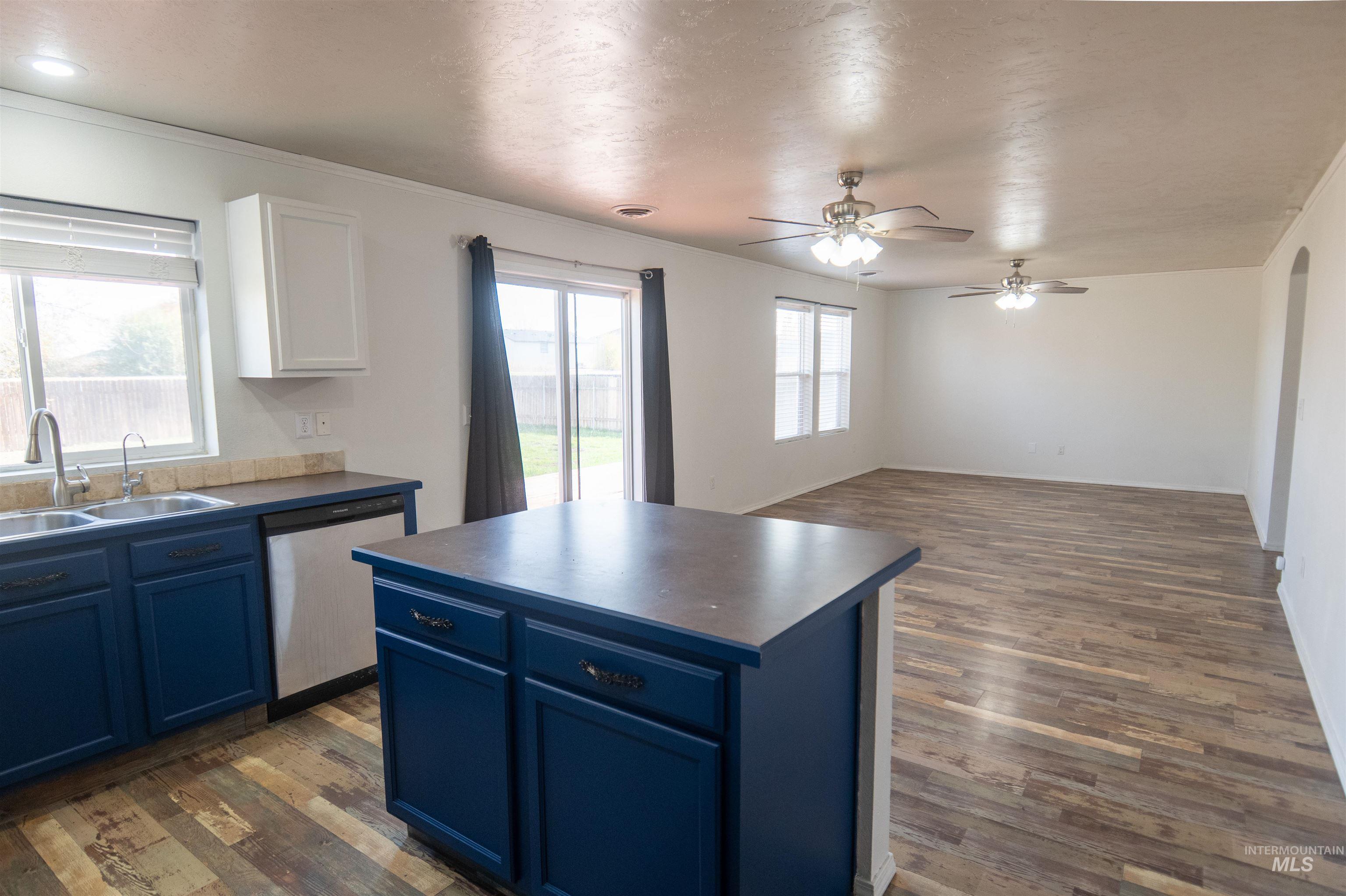 880 Southwest Independence Mountain Home, ID 83647 - Photo 50 of 50 Kitchen with blue cabinetry, dark wood-style flooring, open floor plan, and a textured ceiling