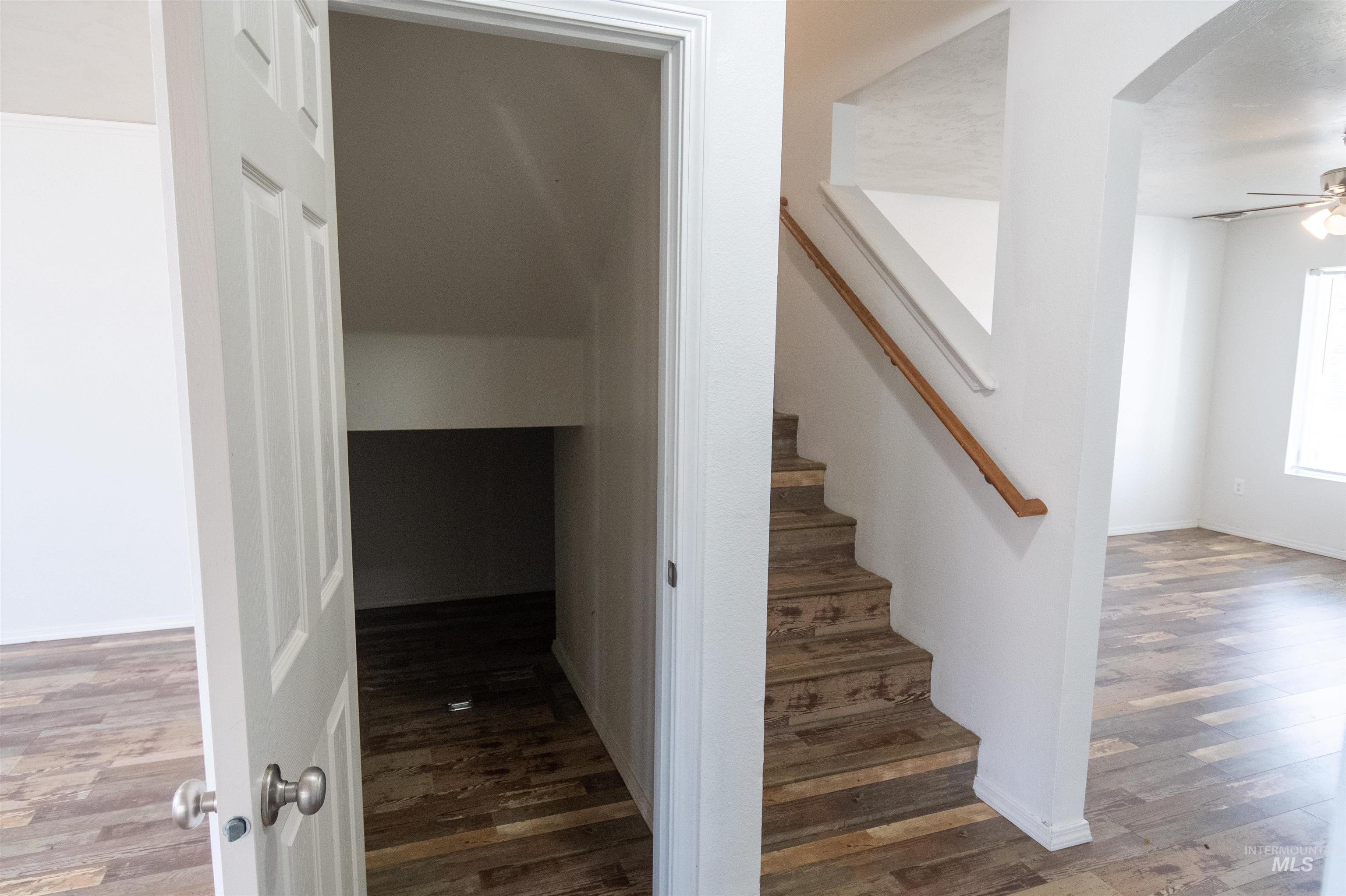880 Southwest Independence Mountain Home, ID 83647 - Photo 20 of 50 Stairs with wood finished floors, arched walkways, and a ceiling fan