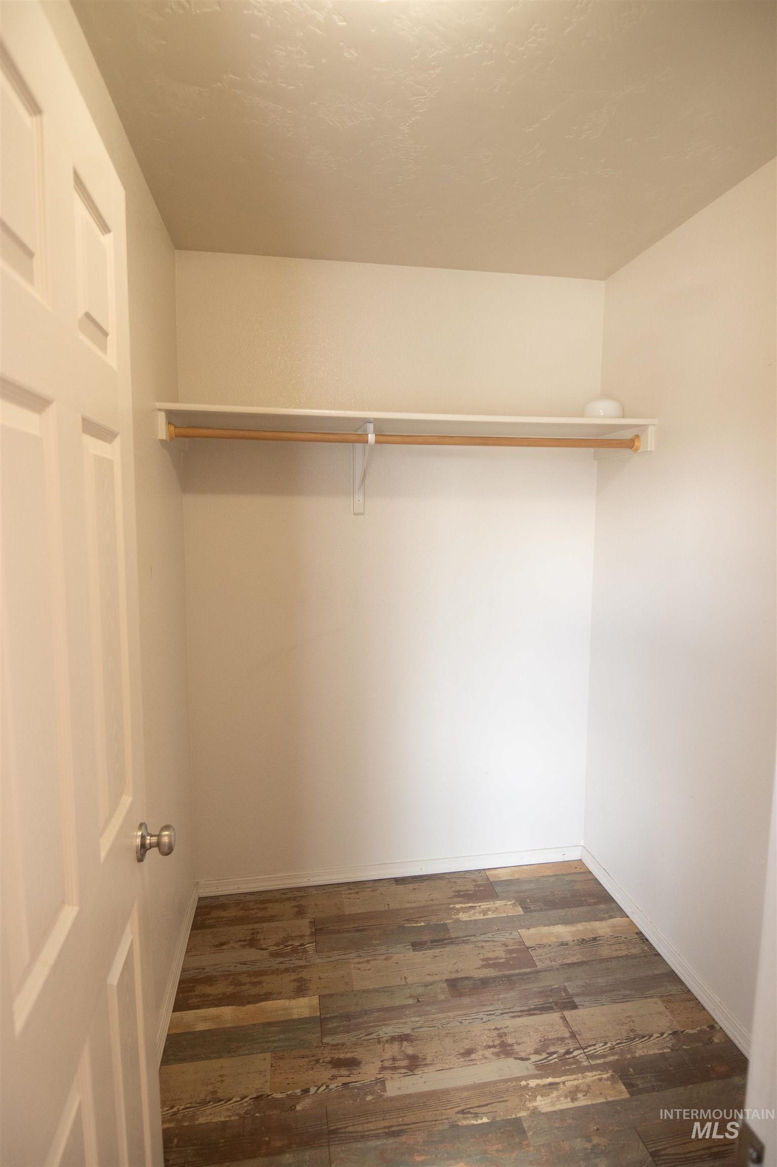 880 Southwest Independence Mountain Home, ID 83647 - Photo 28 of 50 Walk in closet featuring dark wood finished floors