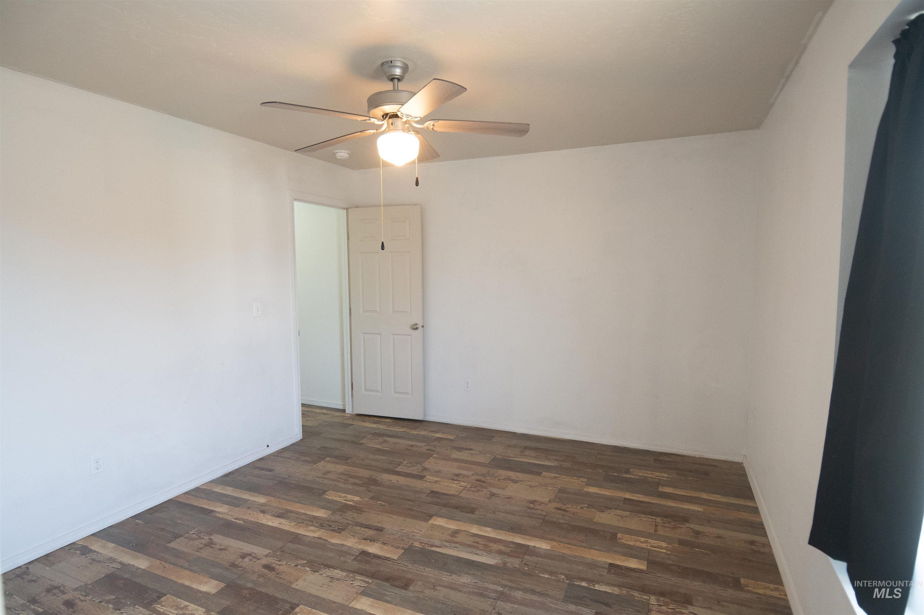 880 Southwest Independence Mountain Home, ID 83647 - Photo 29 of 50 Spare room featuring dark wood-type flooring and a ceiling fan