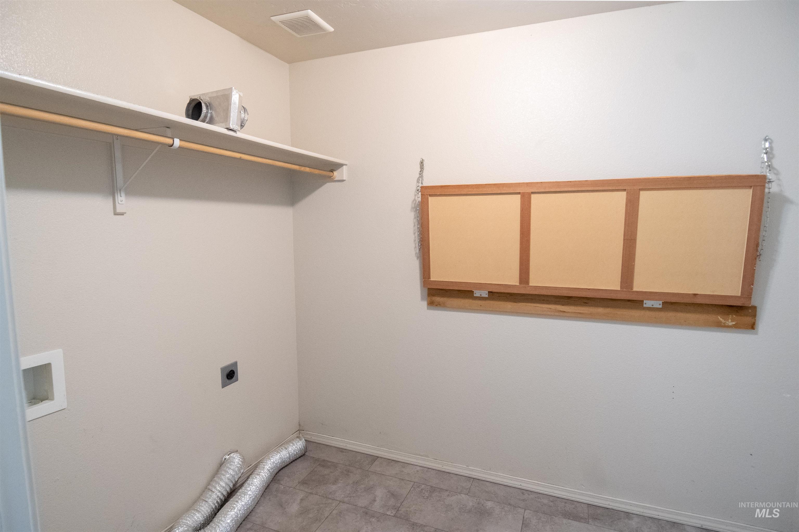 880 Southwest Independence Mountain Home, ID 83647 - Photo 33 of 50 Laundry area featuring hookup for a washing machine, electric dryer hookup, and tile patterned flooring