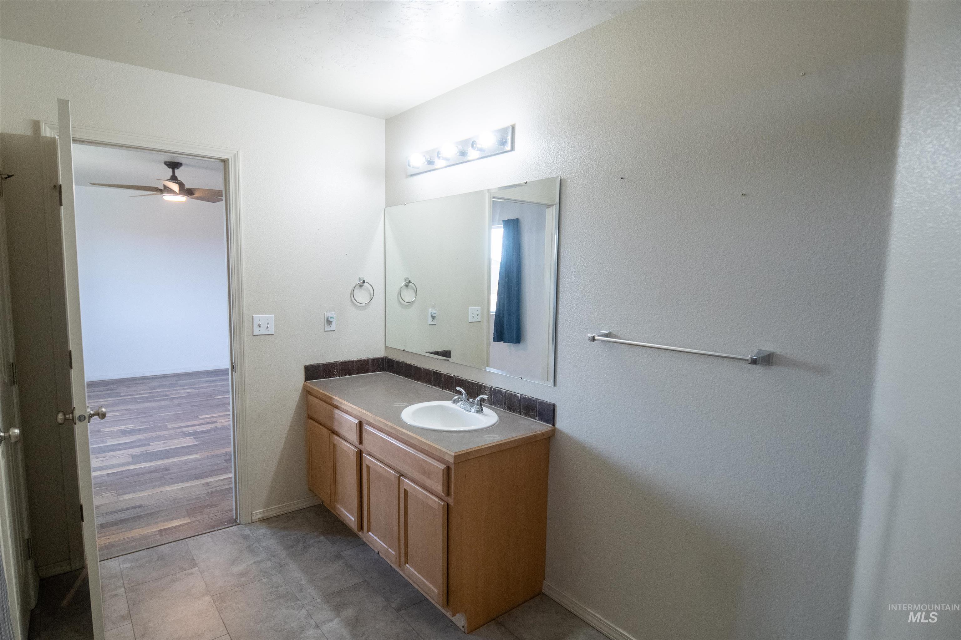 880 Southwest Independence Mountain Home, ID 83647 - Photo 39 of 50 Bathroom featuring vanity, light tile patterned floors, and a ceiling fan
