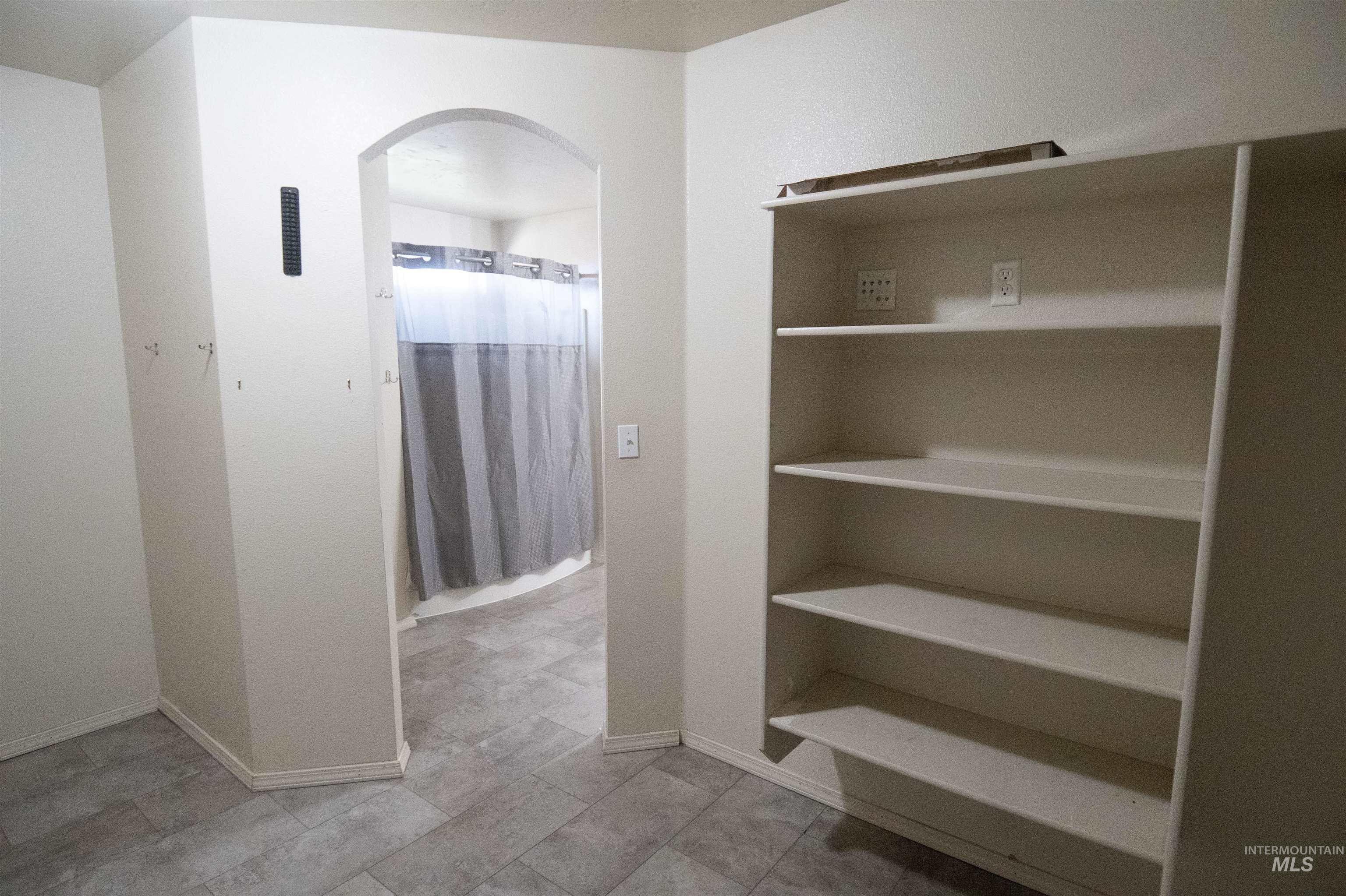 880 Southwest Independence Mountain Home, ID 83647 - Photo 44 of 50 Bathroom with baseboards and a shower with shower curtain
