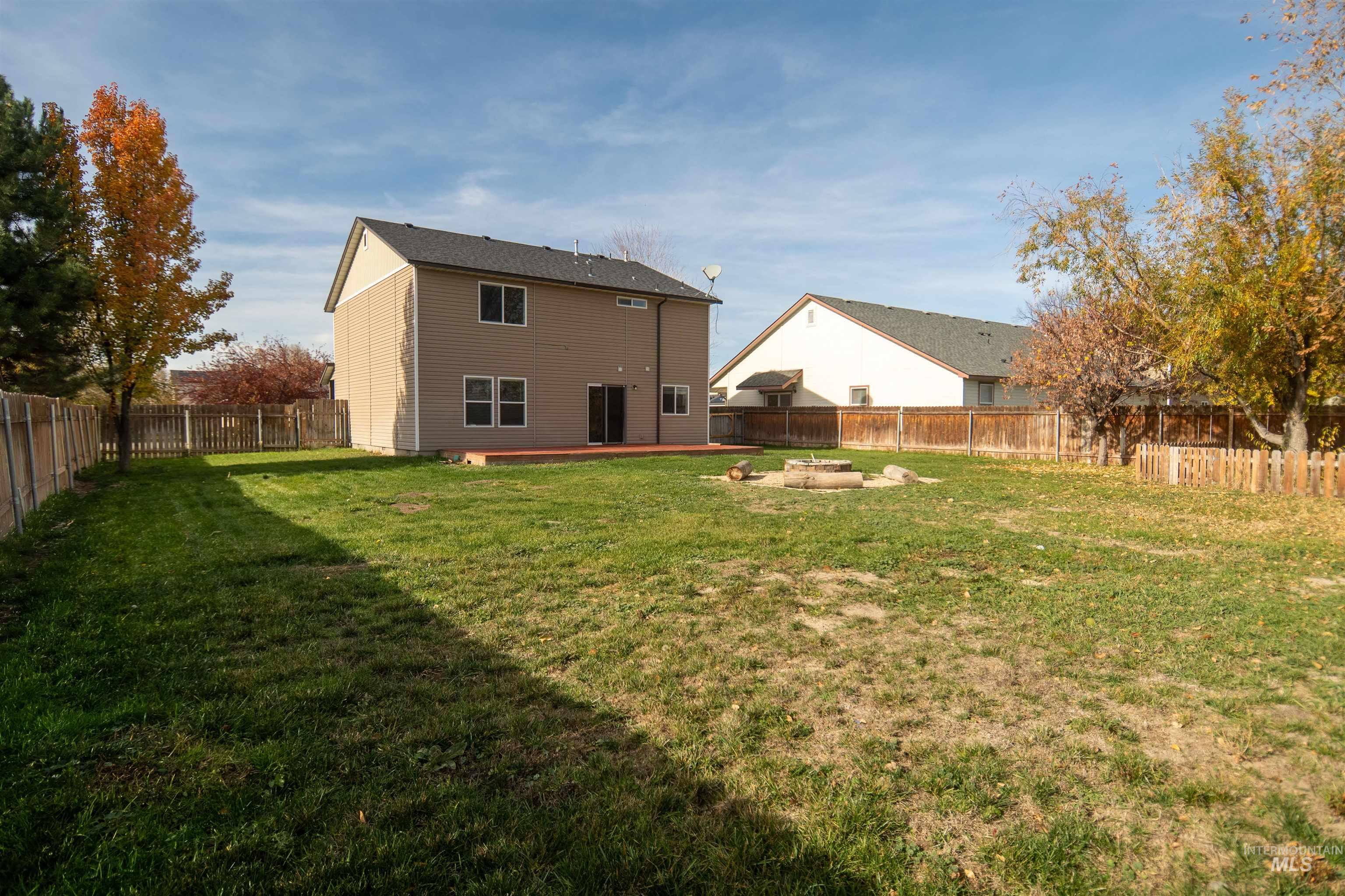 880 Southwest Independence Mountain Home, ID 83647 - Photo 48 of 50 Back of property with a fenced backyard, a patio area, and an outdoor fire pit