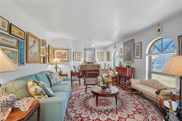 a living room with furniture a rug and a window