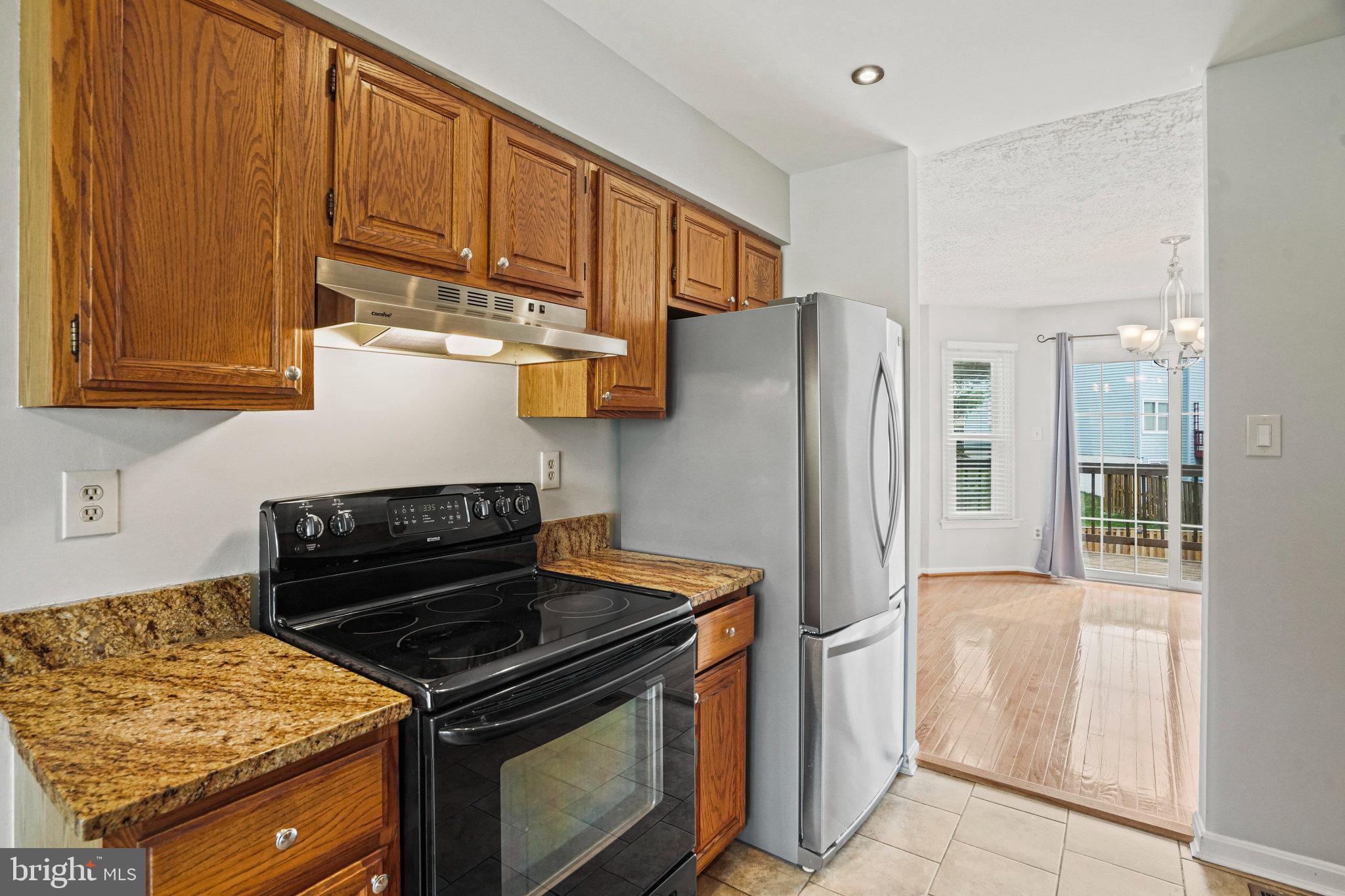 2913 Gracefield Road Silver Spring, MD 20904 - Photo 12 of 53 a kitchen with stainless steel appliances granite countertop a refrigerator stove and cabinets