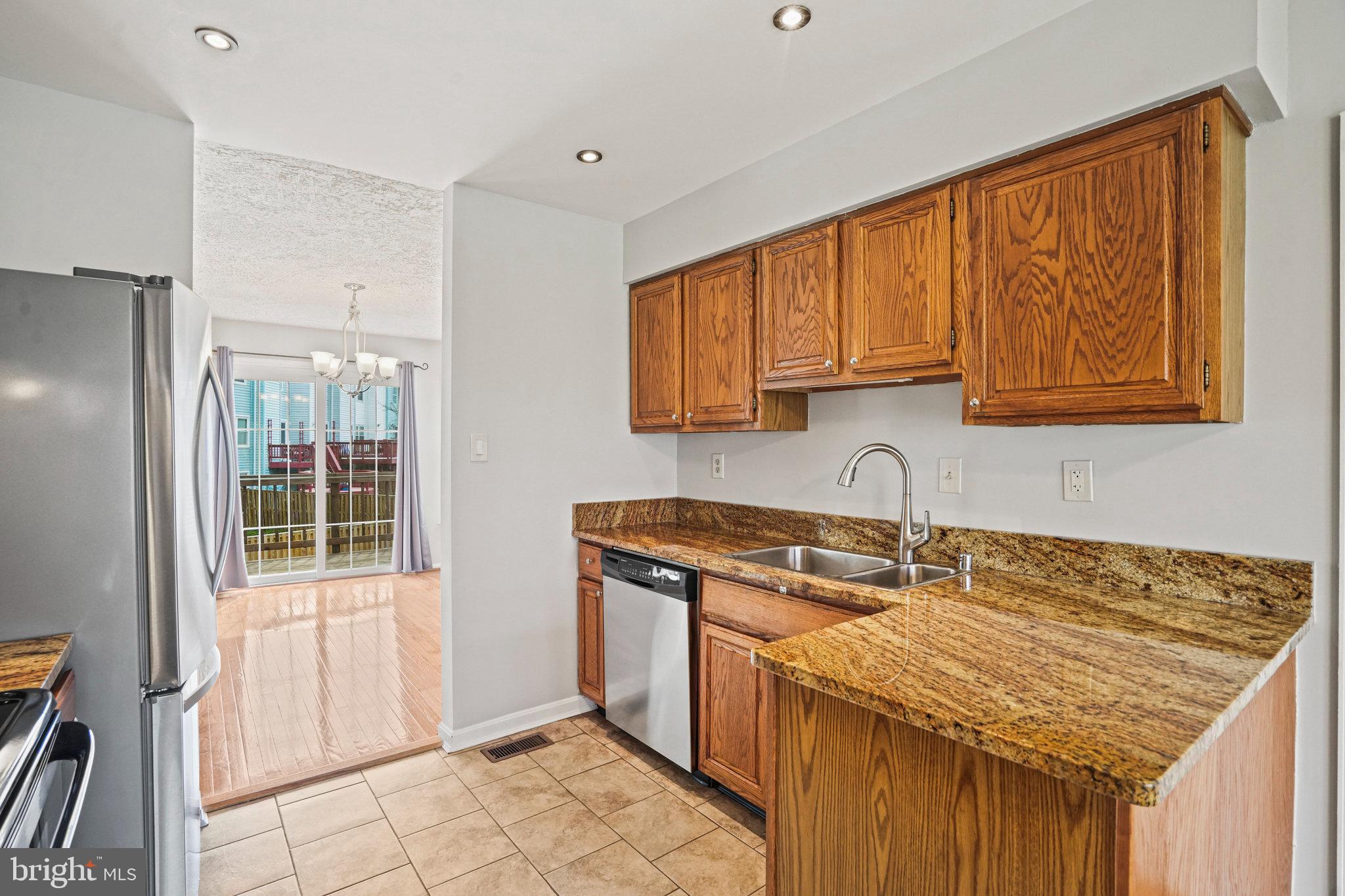 2913 Gracefield Road Silver Spring, MD 20904 - Photo 13 of 53 a kitchen with a sink stove and cabinets