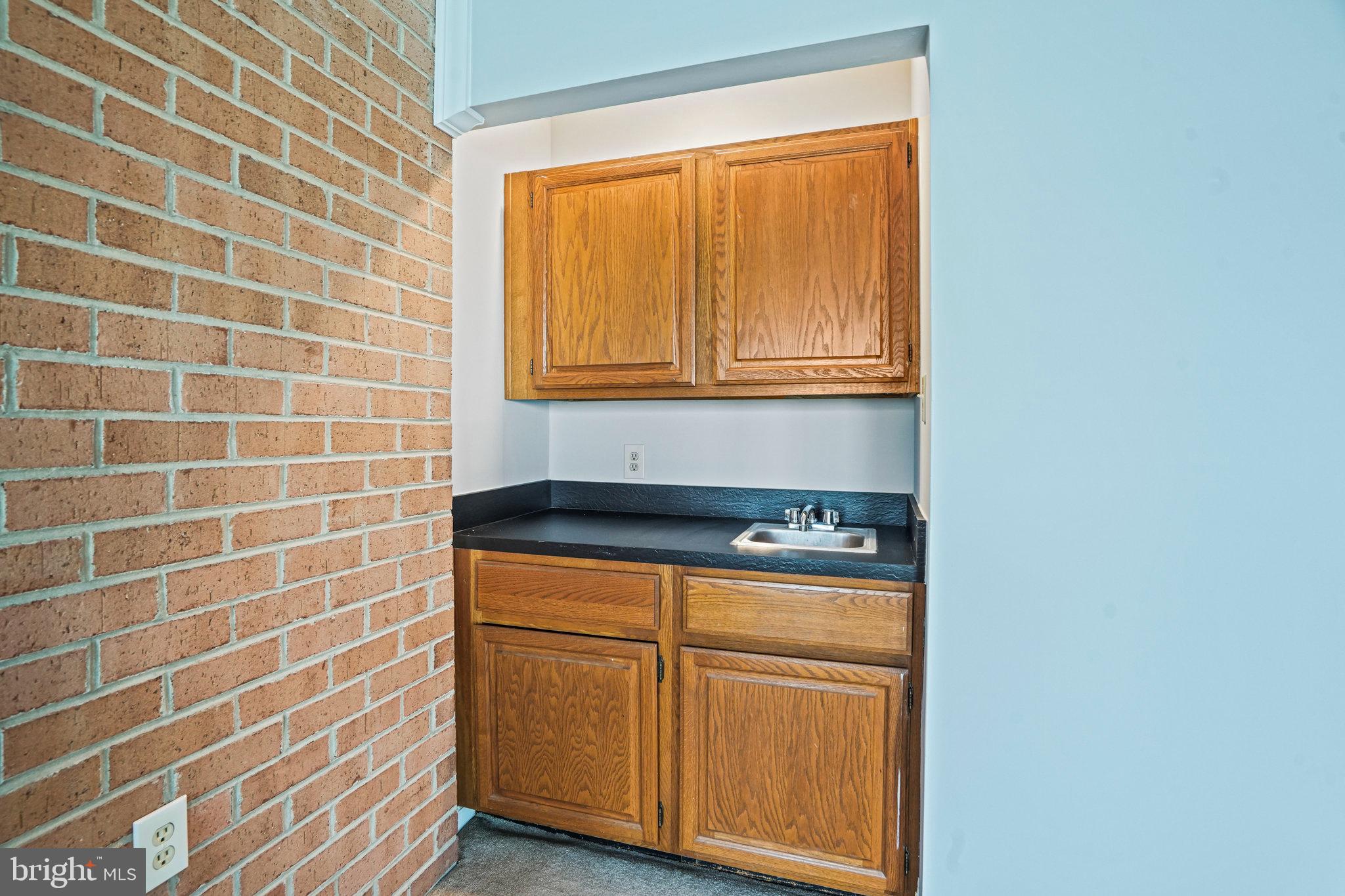 2913 Gracefield Road Silver Spring, MD 20904 - Photo 21 of 53 a kitchen with granite countertop white cabinets and a wooden floor