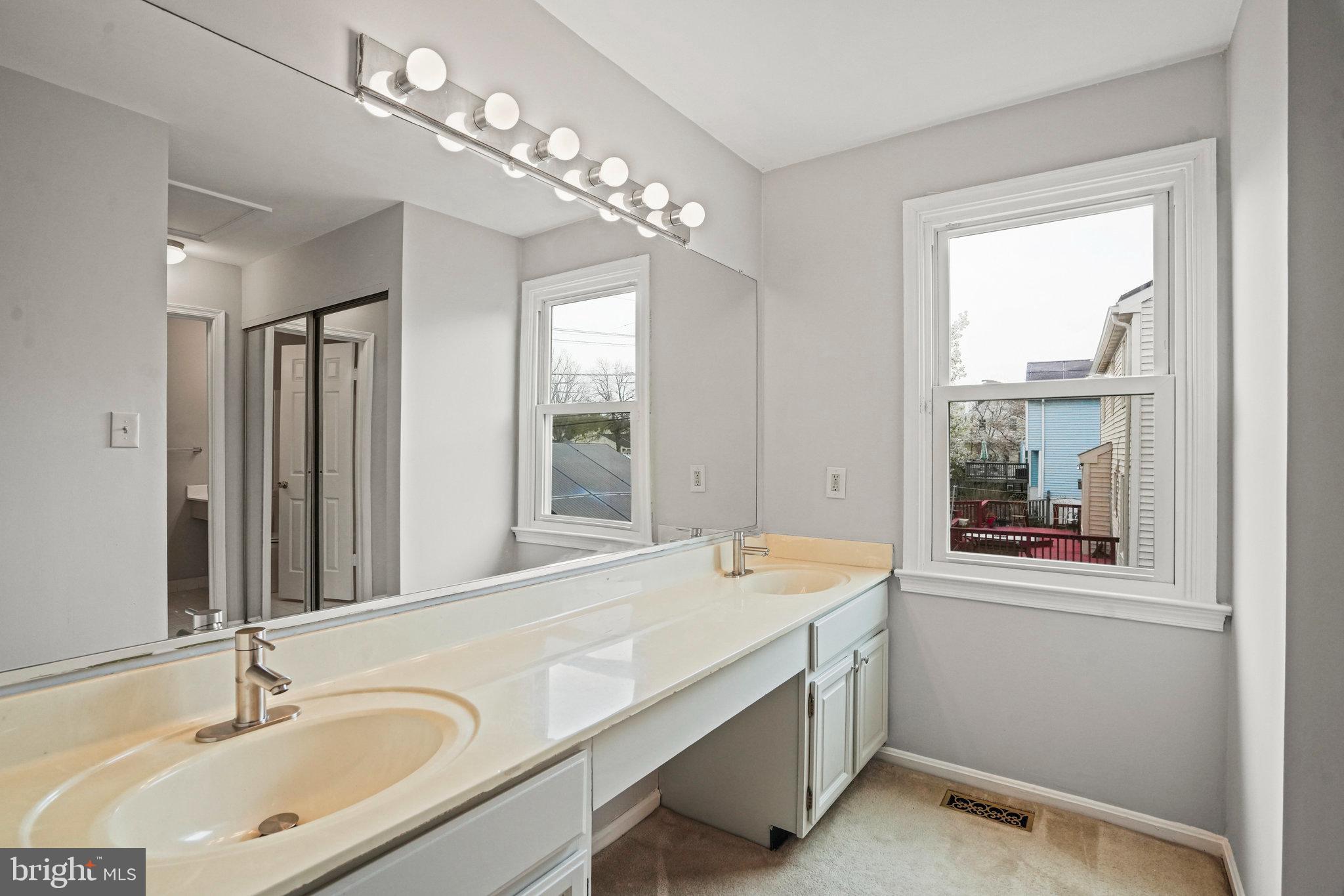 2913 Gracefield Road Silver Spring, MD 20904 - Photo 31 of 53 a bathroom with a sink double vanity and a tub
