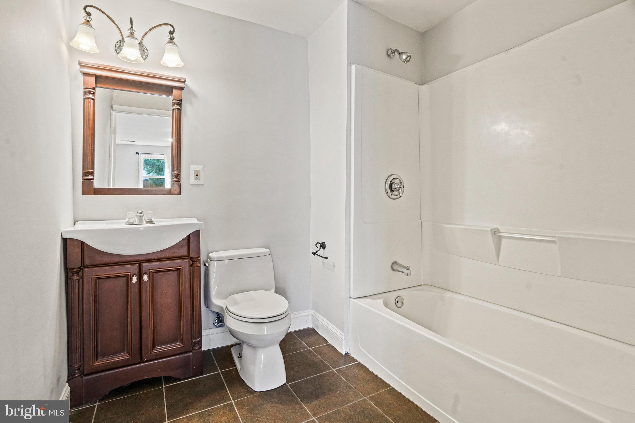 2913 Gracefield Road Silver Spring, MD 20904 - Photo 46 of 53 a bathroom with a toilet a sink and bathtub