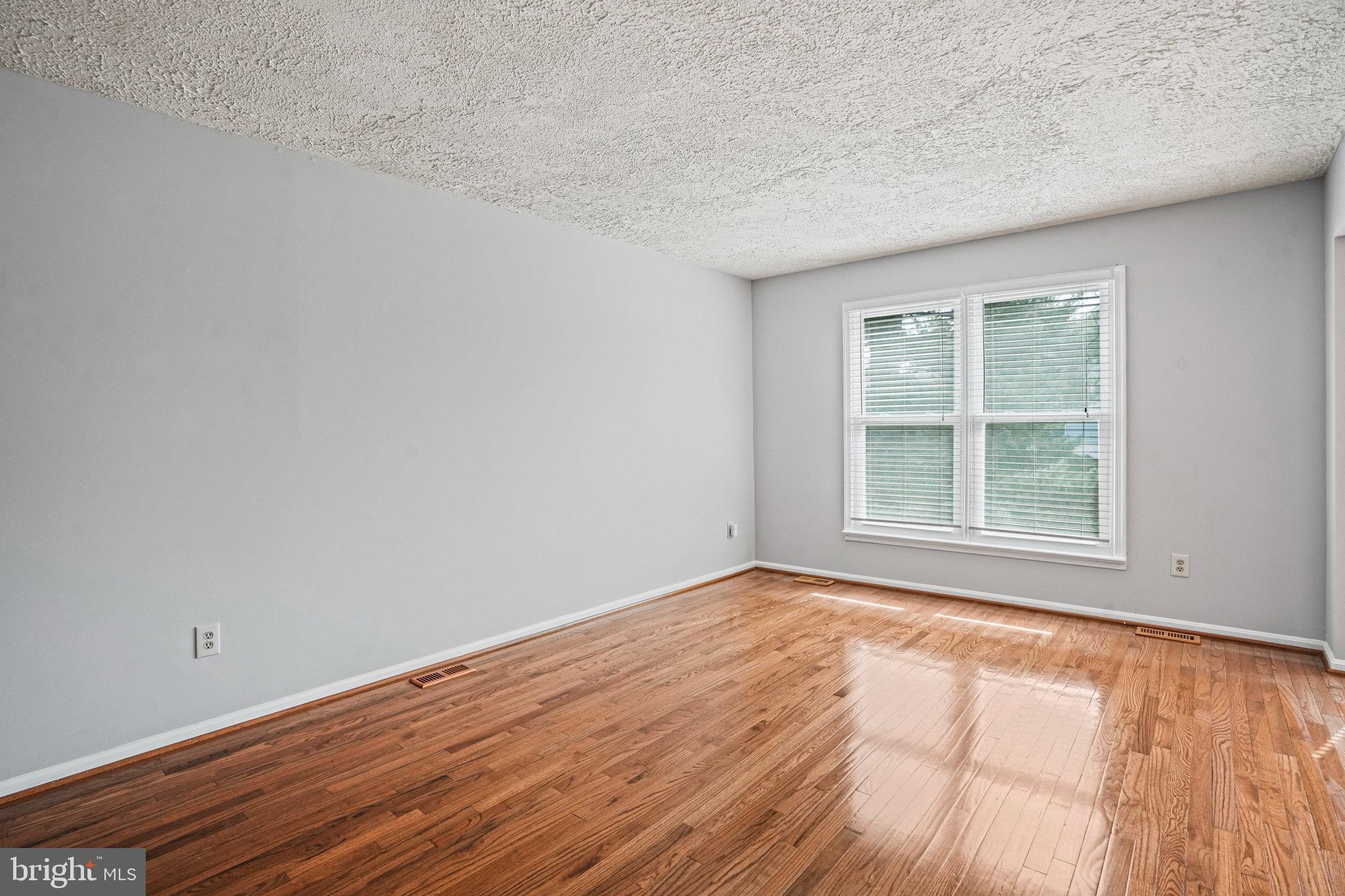 2913 Gracefield Road Silver Spring, MD 20904 - Photo 8 of 53 a view of an empty room with wooden floor and a window