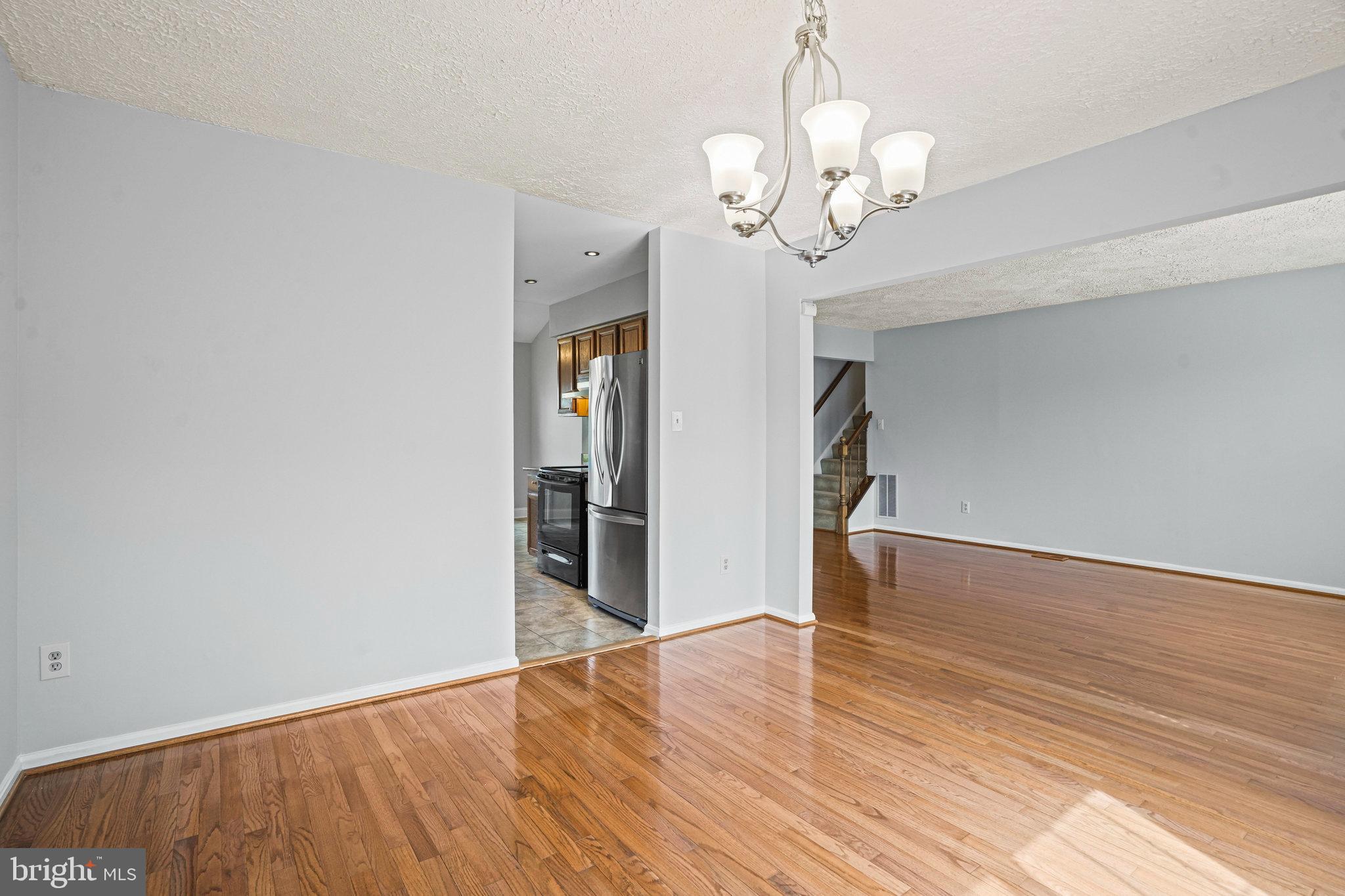 2913 Gracefield Road Silver Spring, MD 20904 - Photo 9 of 53 a view of a room with wooden floor and chandelier