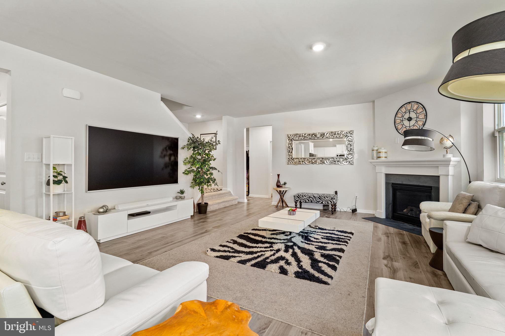 1268 Pimpernell Path Middletown, DE 19709 - Photo 14 of 51 a living room with furniture a flat screen tv and a fireplace