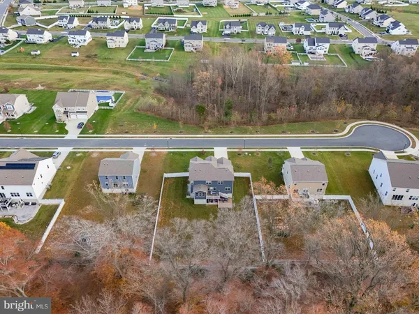an aerial view of a house with a big yard