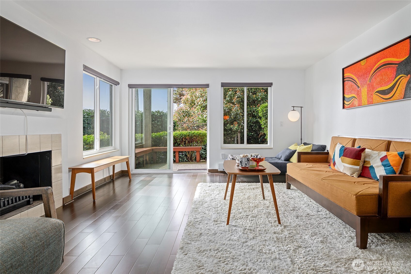 135 North 46th Street, Unit 101 Seattle, WA 98103 - Photo 1 of 30 a living room with furniture a flat screen tv and a fireplace