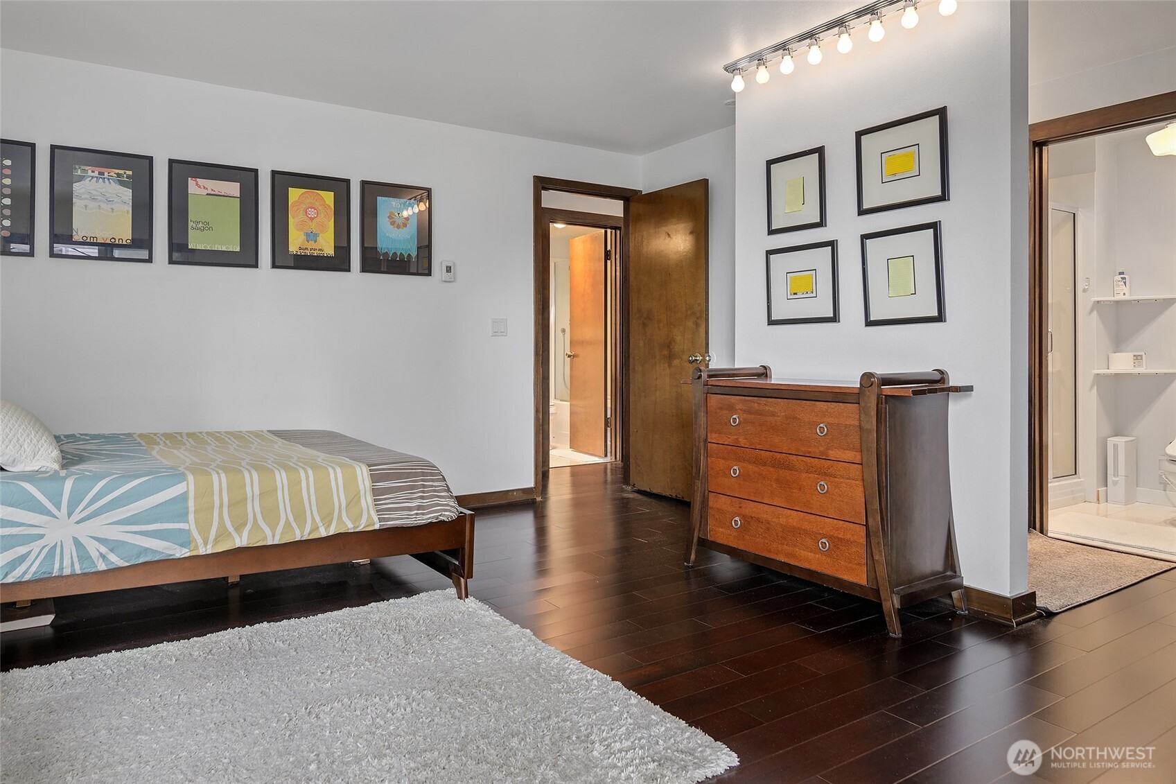 135 North 46th Street, Unit 101 Seattle, WA 98103 - Photo 12 of 30 a bedroom with a bed and wooden floor