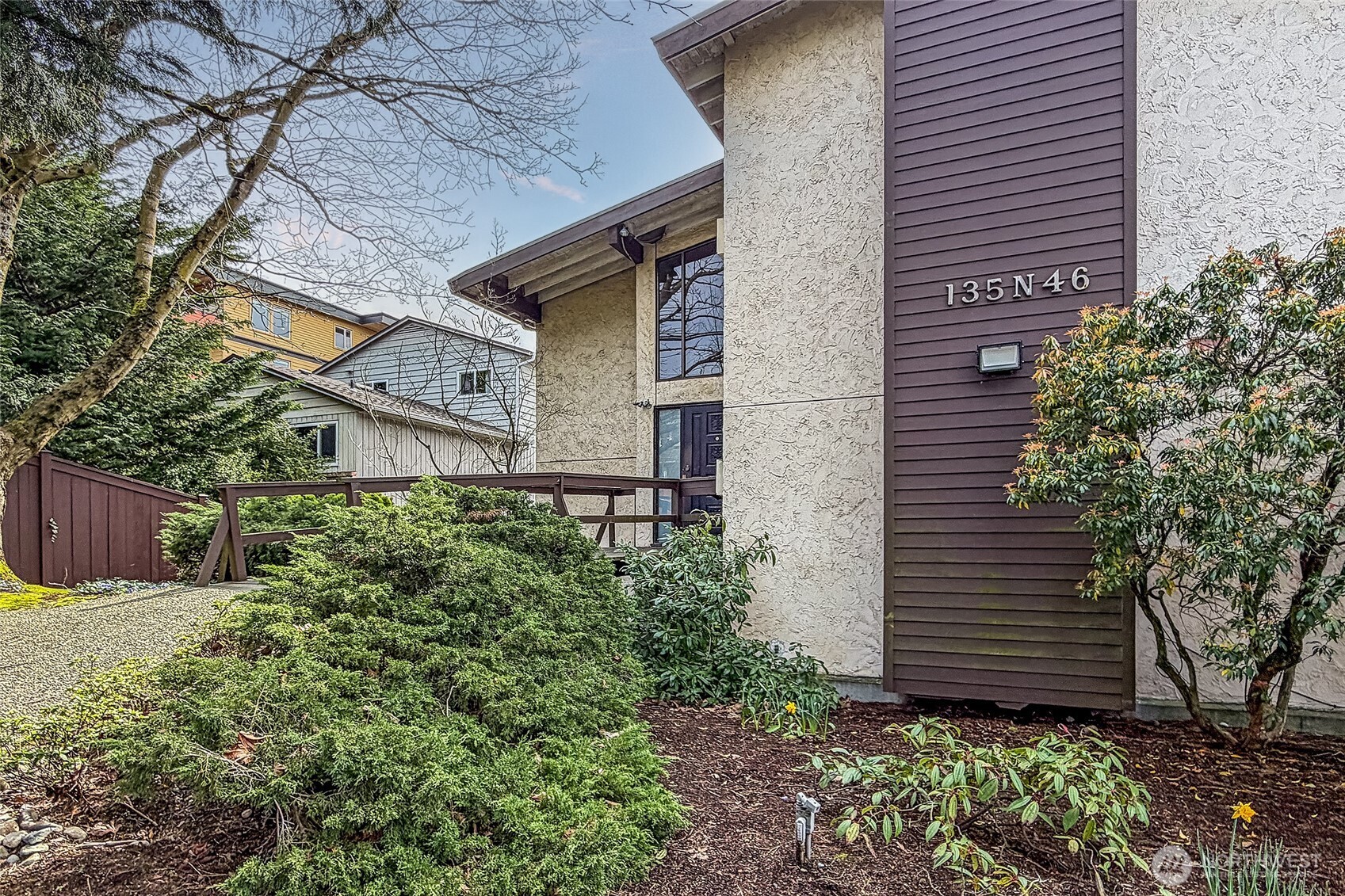 135 North 46th Street, Unit 101 Seattle, WA 98103 - Photo 23 of 30 a view of a house with a yard and plants