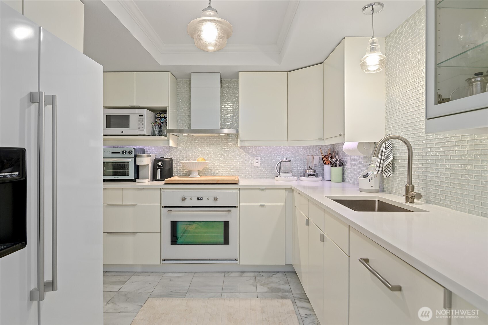 135 North 46th Street, Unit 101 Seattle, WA 98103 - Photo 4 of 30 a kitchen with cabinets stainless steel appliances and sink