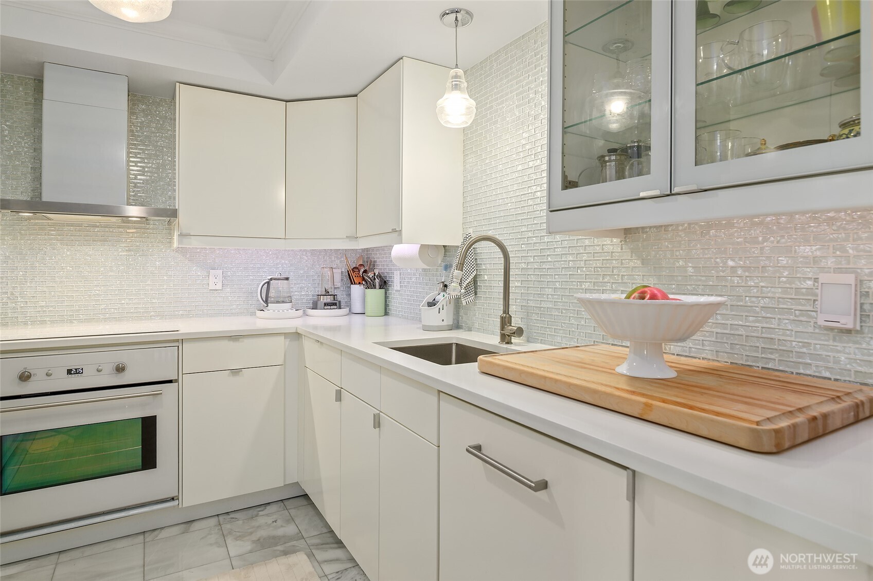 135 North 46th Street, Unit 101 Seattle, WA 98103 - Photo 5 of 30 a kitchen with a sink dishwasher and white cabinets