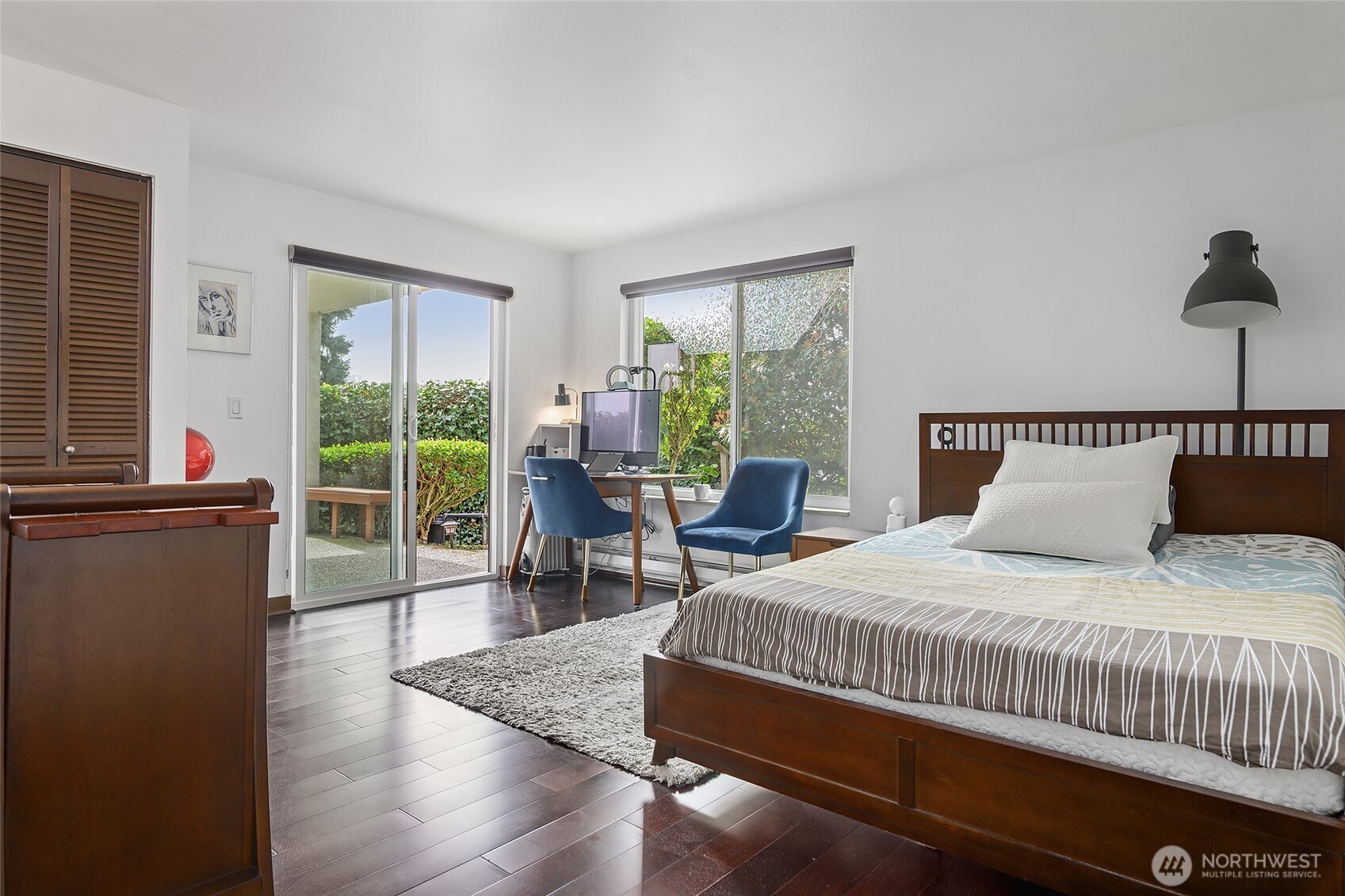 135 North 46th Street, Unit 101 Seattle, WA 98103 - Photo 10 of 30 a bedroom with a bed and wooden floor