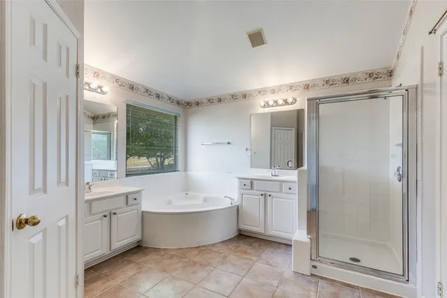 a large bathroom with a double vanity sink toilet mirror and bathtub
