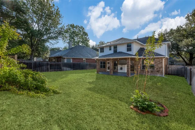 a view of a house with a backyard