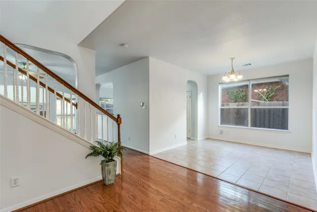 a view of an entryway with wooden floor and door