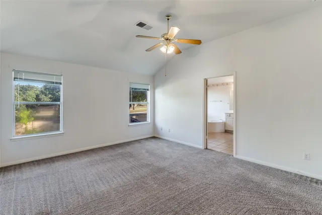 an empty room with windows and closet