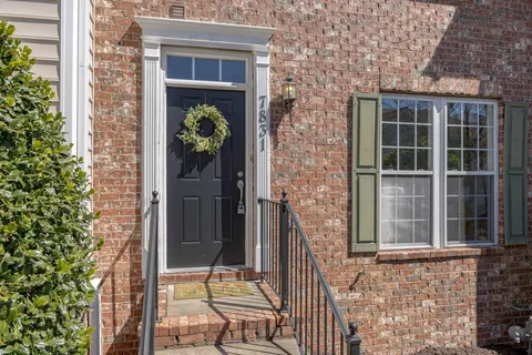 front view of a brick house with a large window