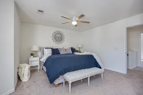 a bedroom with a bed and window