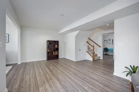 a view of a workspace with furniture and wooden floor