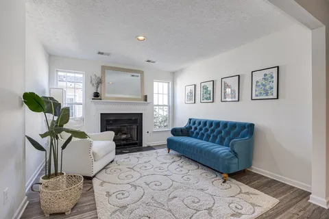 a view of a patio with a table and chairs and potted plants